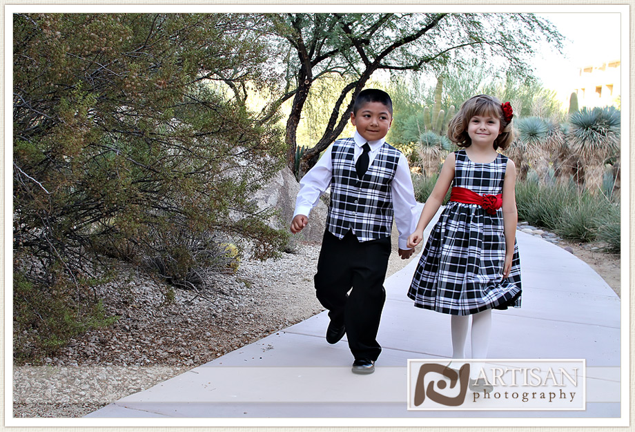 ring bearer and flwer girls walking holding hands