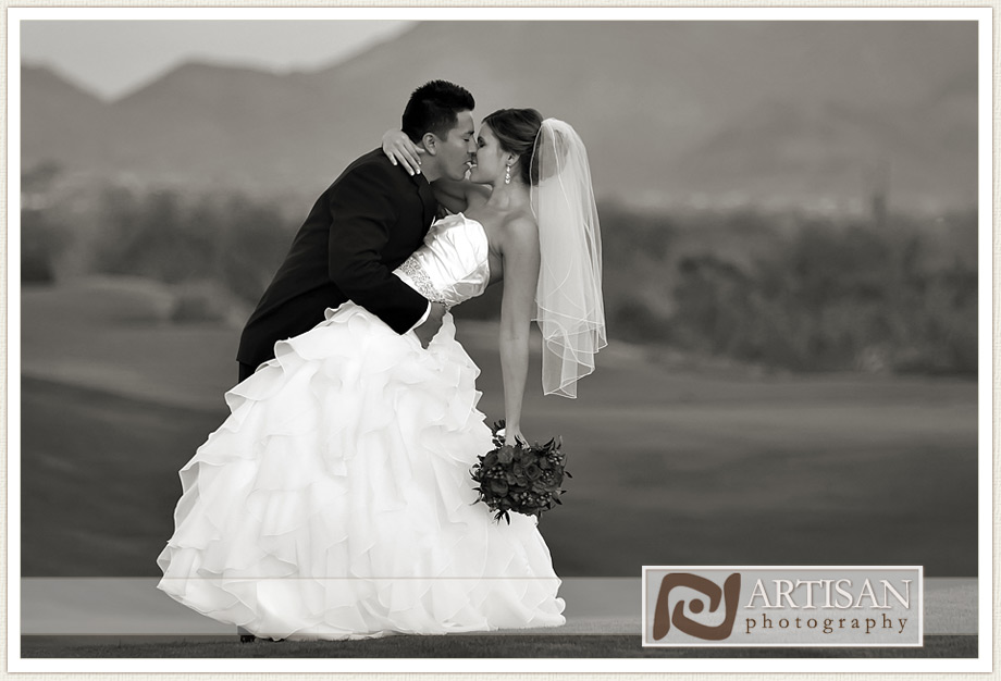bride and groom kissing and beautiful landscape at the JW Marriott Desert Ridge